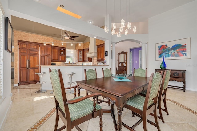 2613 59th St S, Gulfport, FL 33707 - dining area with inlaid floor details, decorative columns, ceiling fan, arched walkways, and recessed lighting