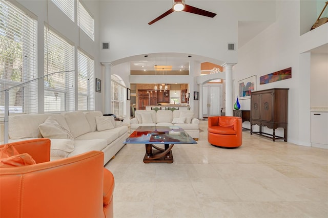 2613 59th St S, Gulfport, FL 33707 - living room with ornate columns, a high ceiling, arched walkways, and ceiling fan