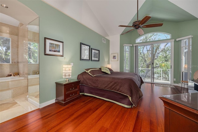 2613 59th St S, Gulfport, FL 33707 - bedroom with access to exterior, wood finished floors, ensuite bathroom, arched walkways, and ceiling fan
