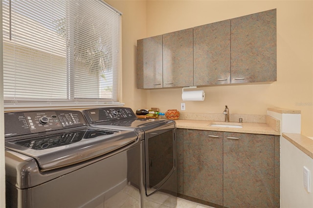 2613 59th St S, Gulfport, FL 33707 - laundry room featuring washer and clothes dryer, cabinet space, and light tile patterned flooring