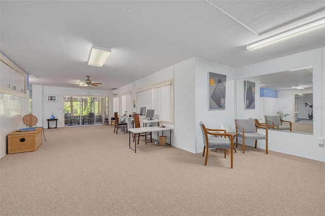2613 59th St S, Gulfport, FL 33707 - living area with carpet floors, a ceiling fan, and a textured ceiling