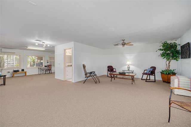 2613 59th St S, Gulfport, FL 33707 - living area with carpet, a wall unit AC, and ceiling fan