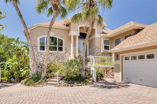 2613 59th St S, Gulfport, FL 33707 - view of front of house featuring stucco siding, decorative driveway, and stone siding