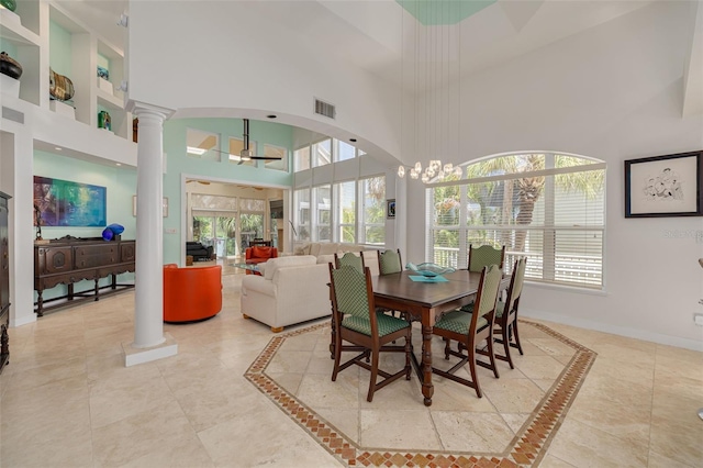 2613 59th St S, Gulfport, FL 33707 - dining space with decorative columns, a high ceiling, and plenty of natural light