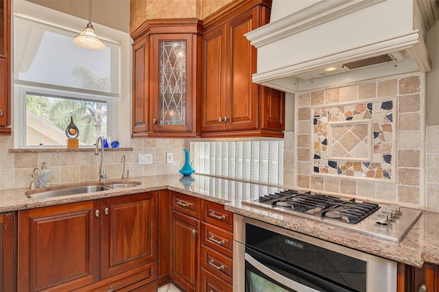 2613 59th St S, Gulfport, FL 33707 - kitchen featuring wall oven, custom exhaust hood, stainless steel gas stovetop, light stone counters, and decorative backsplash