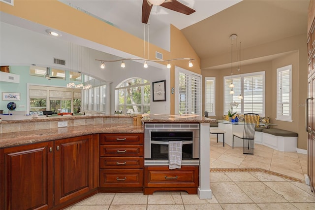 2613 59th St S, Gulfport, FL 33707 - kitchen featuring healthy amount of natural light, a ceiling fan, hanging light fixtures, and high vaulted ceiling