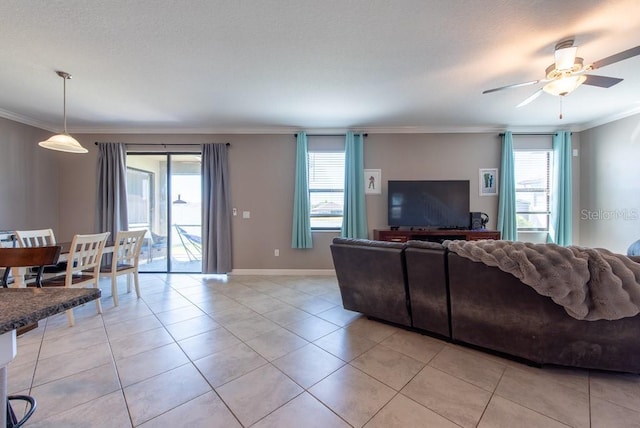 living room featuring light tile patterned floors, a wealth of natural light, and ornamental molding