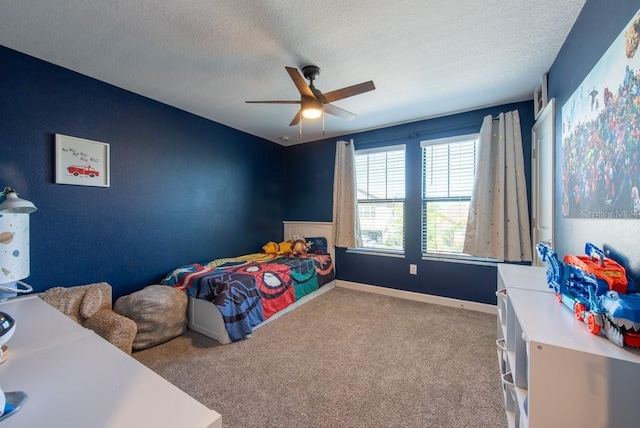 bedroom with carpet floors, a textured ceiling, and a ceiling fan