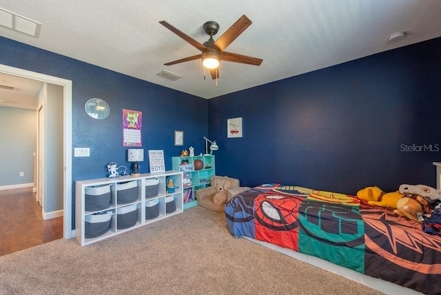 carpeted bedroom featuring baseboards, a ceiling fan, and visible vents