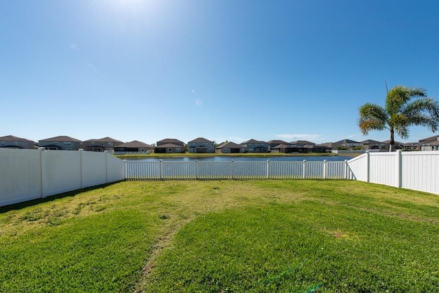 view of yard with a fenced backyard and a residential view