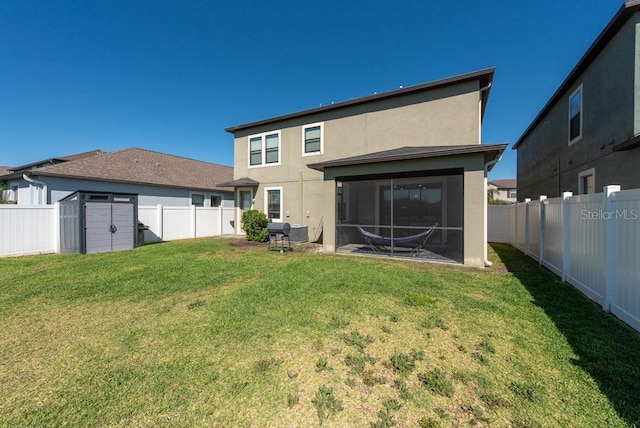 rear view of property featuring a shed, a fenced backyard, and stucco siding