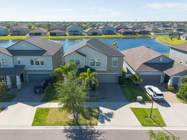 bird's eye view with a residential view and a water view