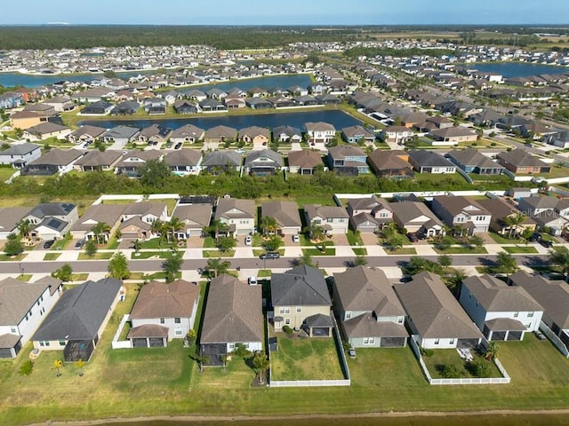birds eye view of property with a water view and a residential view
