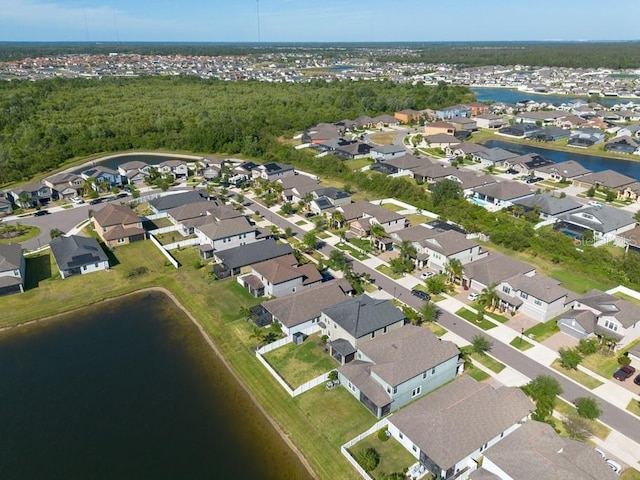 drone / aerial view with a water view and a residential view
