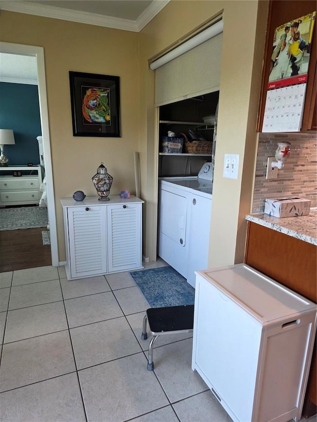 6190 80th St N Unit 204, Saint Petersburg, FL 33709 - laundry area with washer and dryer, crown molding, and light tile patterned floors
