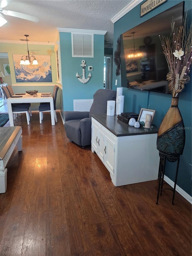 6190 80th St N Unit 204, Saint Petersburg, FL 33709 - living area featuring ornamental molding, dark wood-type flooring, a chandelier, a textured ceiling, and ceiling fan