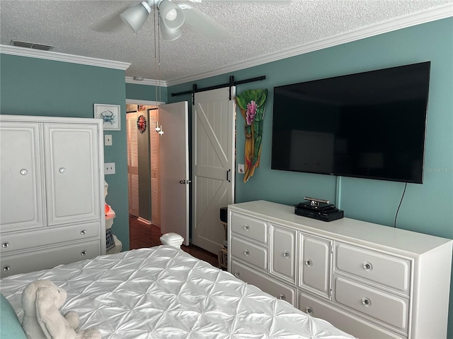 6190 80th St N Unit 204, Saint Petersburg, FL 33709 - bedroom with a textured ceiling, ornamental molding, a barn door, and a ceiling fan