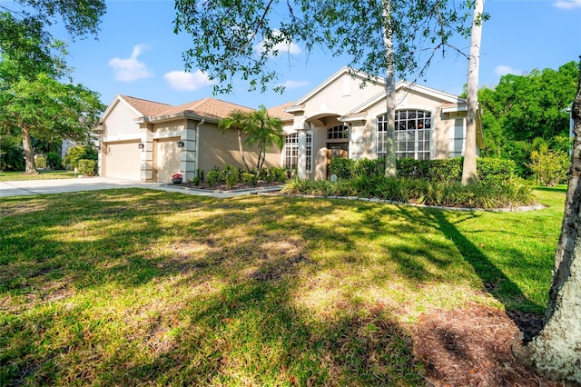 ranch-style house featuring stucco siding, an attached garage, concrete driveway, and a front yard