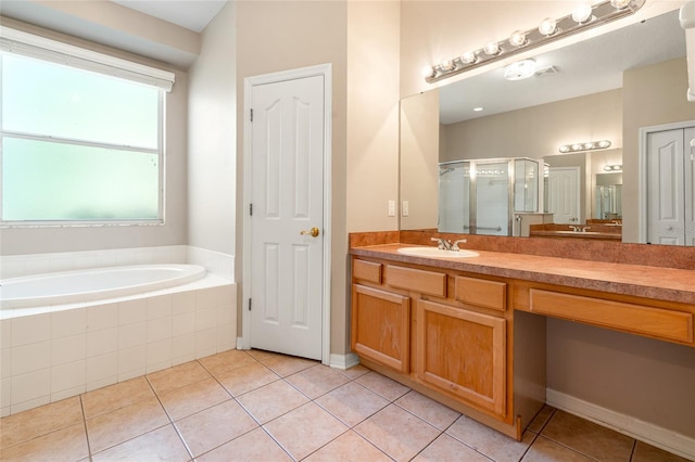 bathroom with tile patterned floors, a garden tub, vanity, and a shower stall