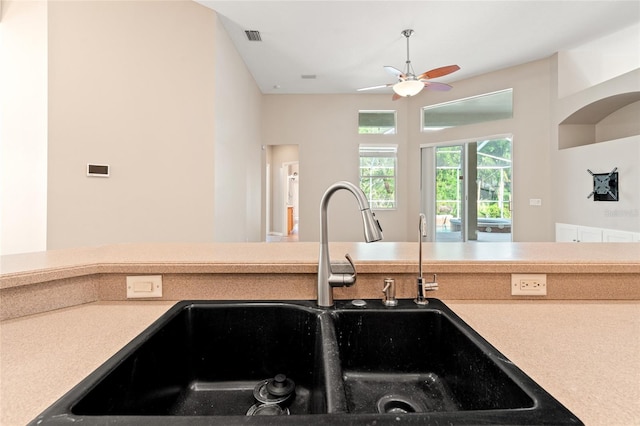 kitchen featuring light countertops, visible vents, a ceiling fan, and a sink