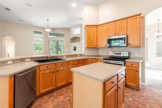 kitchen featuring light countertops, visible vents, a ceiling fan, a sink, and appliances with stainless steel finishes