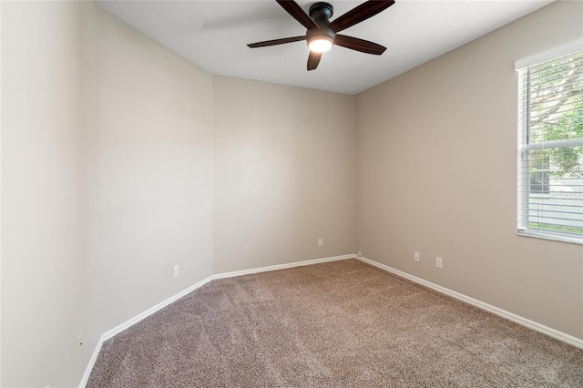 empty room with baseboards, a ceiling fan, and carpet flooring