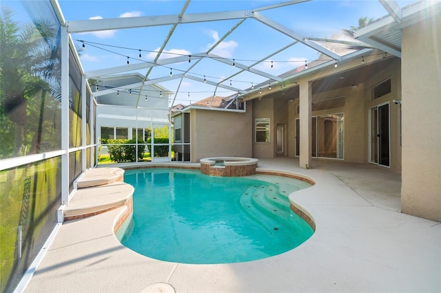 view of pool with a patio area, a lanai, and a pool with connected hot tub