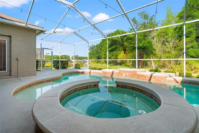 pool featuring a patio area, a lanai, and an in ground hot tub