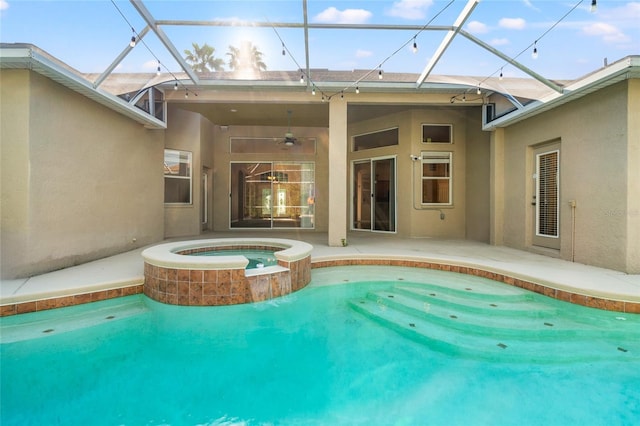 view of swimming pool featuring a lanai, a ceiling fan, a patio, and a pool with connected hot tub