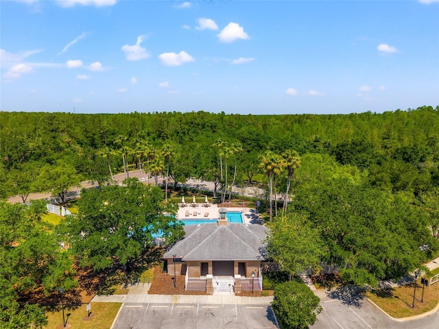 drone / aerial view featuring a view of trees
