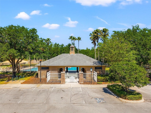 view of property featuring uncovered parking and fence