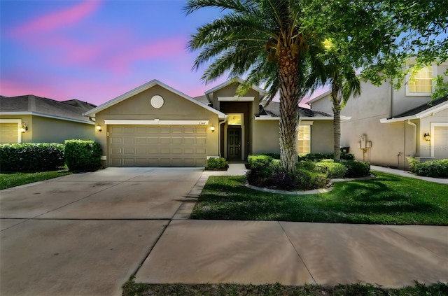 11506 Mansfield Point Dr, Riverview, FL 33569 - view of front facade with a front yard, an attached garage, concrete driveway, and stucco siding