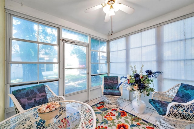 sunroom / solarium with a healthy amount of sunlight and ceiling fan