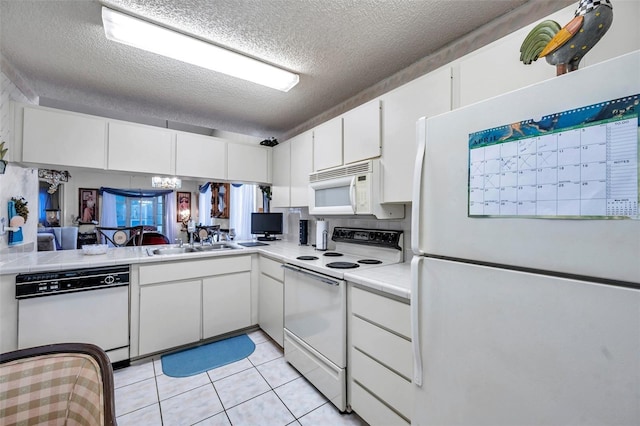 kitchen with white appliances, a textured ceiling, light tile patterned flooring, white cabinets, and a sink