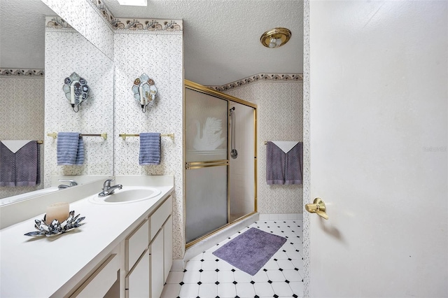 bathroom featuring tile patterned floors, a textured ceiling, wallpapered walls, and a stall shower