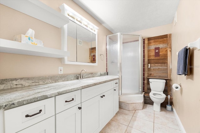 bathroom with a shower stall, tile patterned floors, vanity, and toilet