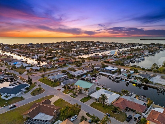 birds eye view of property featuring a water view and a residential view