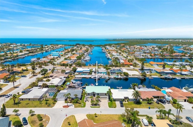 birds eye view of property with a water view and a residential view