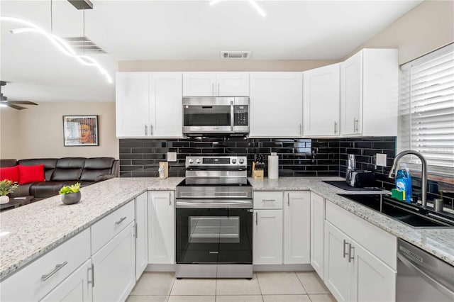 5519 Homewood Dr, Sarasota, FL 34232 - kitchen with a sink, visible vents, white cabinets, and appliances with stainless steel finishes
