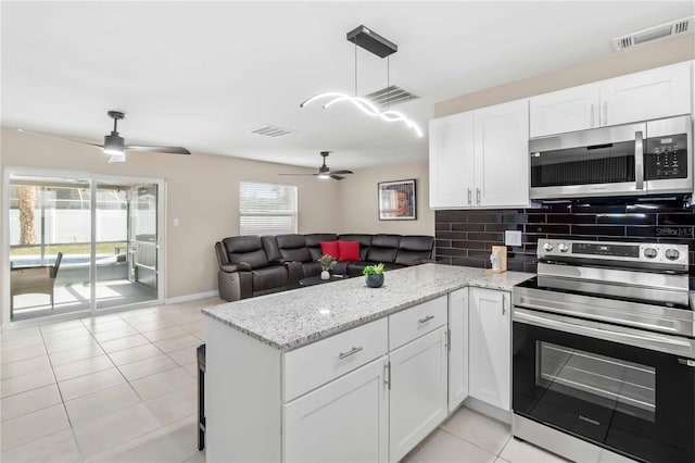 5519 Homewood Dr, Sarasota, FL 34232 - kitchen featuring visible vents, ceiling fan, appliances with stainless steel finishes, and a peninsula