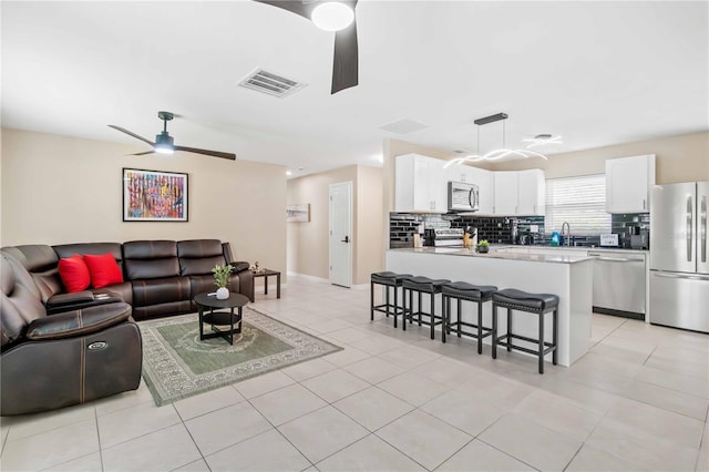 5519 Homewood Dr, Sarasota, FL 34232 - living area with visible vents, ceiling fan, light tile patterned floors, and baseboards