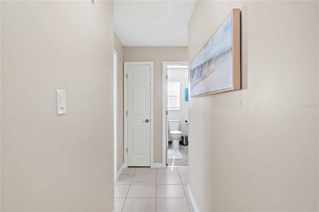 5519 Homewood Dr, Sarasota, FL 34232 - hallway featuring light tile patterned flooring and baseboards