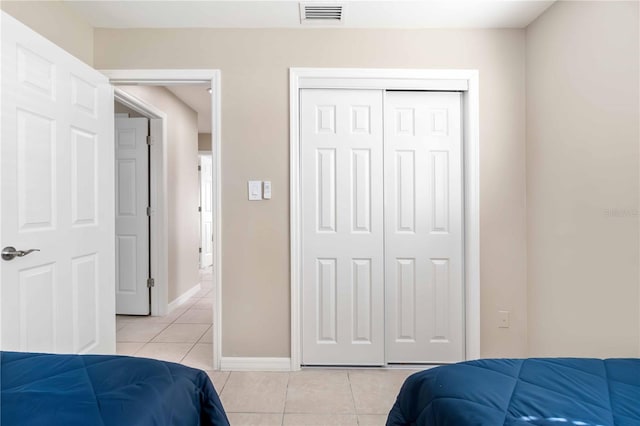 5519 Homewood Dr, Sarasota, FL 34232 - bedroom featuring visible vents, baseboards, a closet, and light tile patterned floors