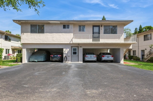 1821 Bough Ave Unit 4, Clearwater, FL 33760 - townhome / multi-family property with stucco siding, driveway, stairway, and a carport
