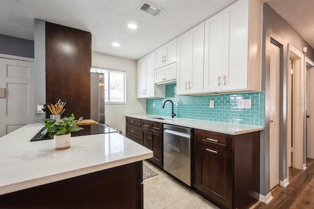 1821 Bough Ave Unit 4, Clearwater, FL 33760 - kitchen with stainless steel appliances, white cabinetry, a textured ceiling, dark brown cabinets, and recessed lighting