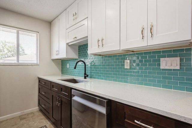 1821 Bough Ave Unit 4, Clearwater, FL 33760 - kitchen with stainless steel dishwasher, white cabinets, tasteful backsplash, and a textured ceiling