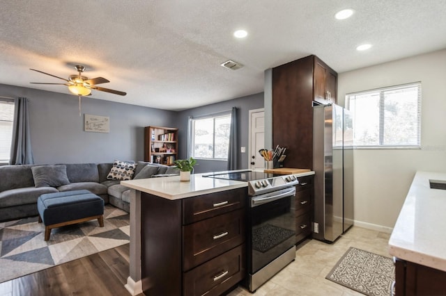 1821 Bough Ave Unit 4, Clearwater, FL 33760 - kitchen featuring appliances with stainless steel finishes, light countertops, a textured ceiling, dark brown cabinets, and open floor plan