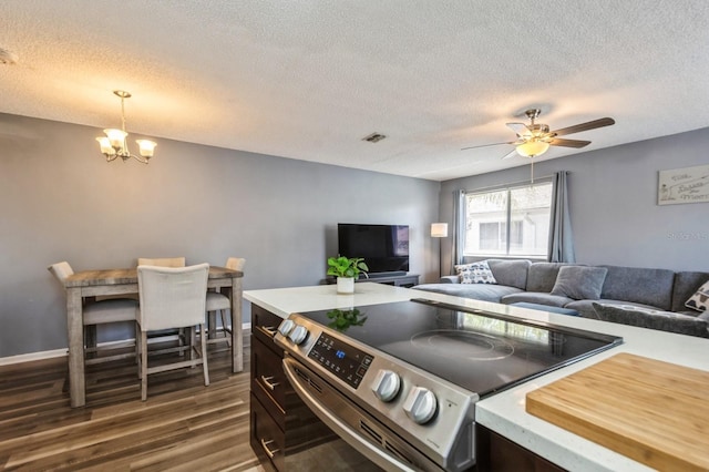 1821 Bough Ave Unit 4, Clearwater, FL 33760 - living room featuring a chandelier, dark wood-style flooring, a textured ceiling, and ceiling fan