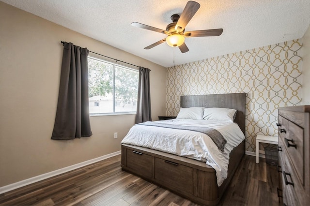 1821 Bough Ave Unit 4, Clearwater, FL 33760 - bedroom with an accent wall, a textured ceiling, wallpapered walls, dark wood-style flooring, and ceiling fan