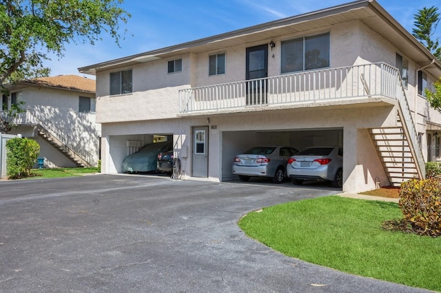 1821 Bough Ave Unit 4, Clearwater, FL 33760 - view of front of home featuring stairway, stucco siding, and driveway